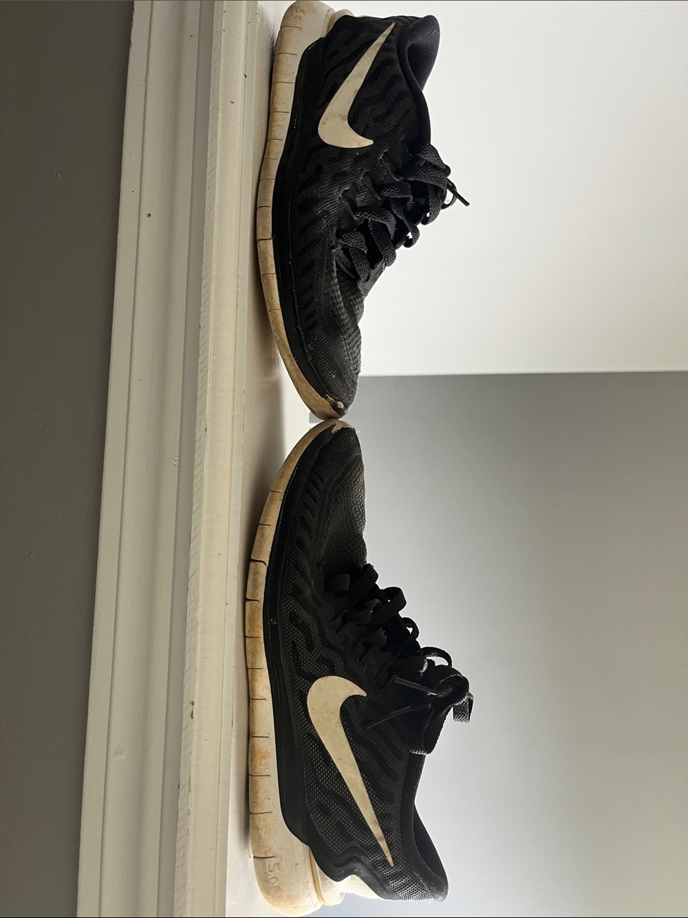 Nike Black Trainers with White Swoosh Accent